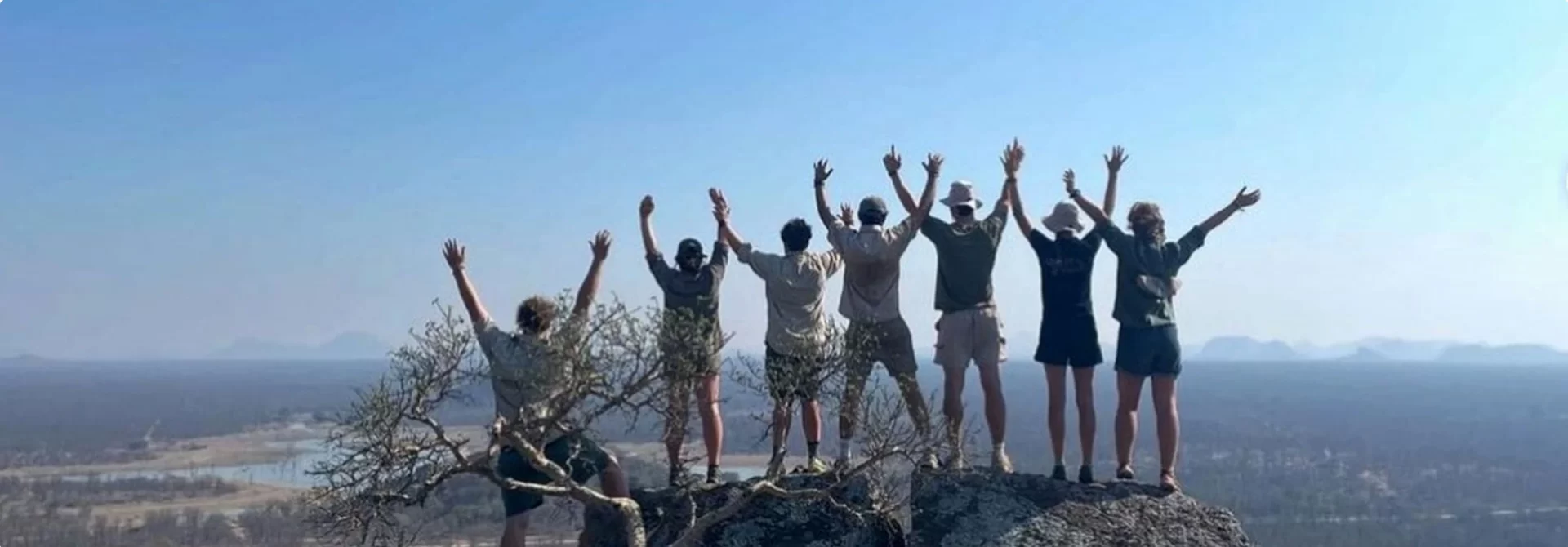 Quest participants standing on a rock